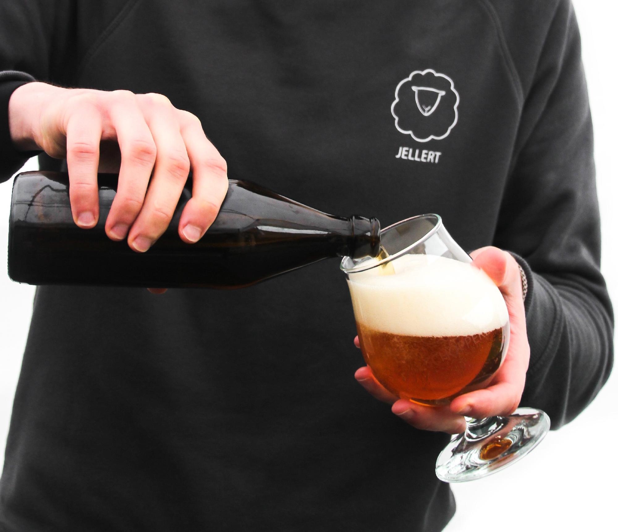Image of someone pooring beer in a glass